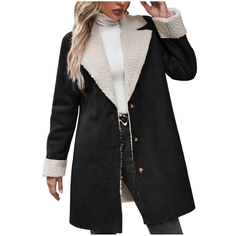 Black coat with white fur collar and cuffs worn by a person on a white background