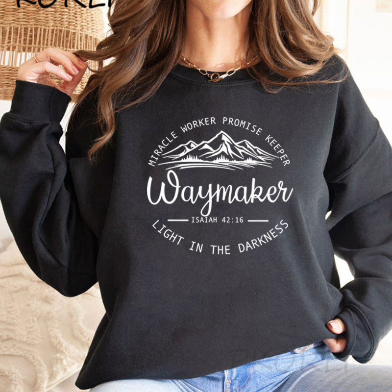Person wearing a black sweatshirt with motivational text and design