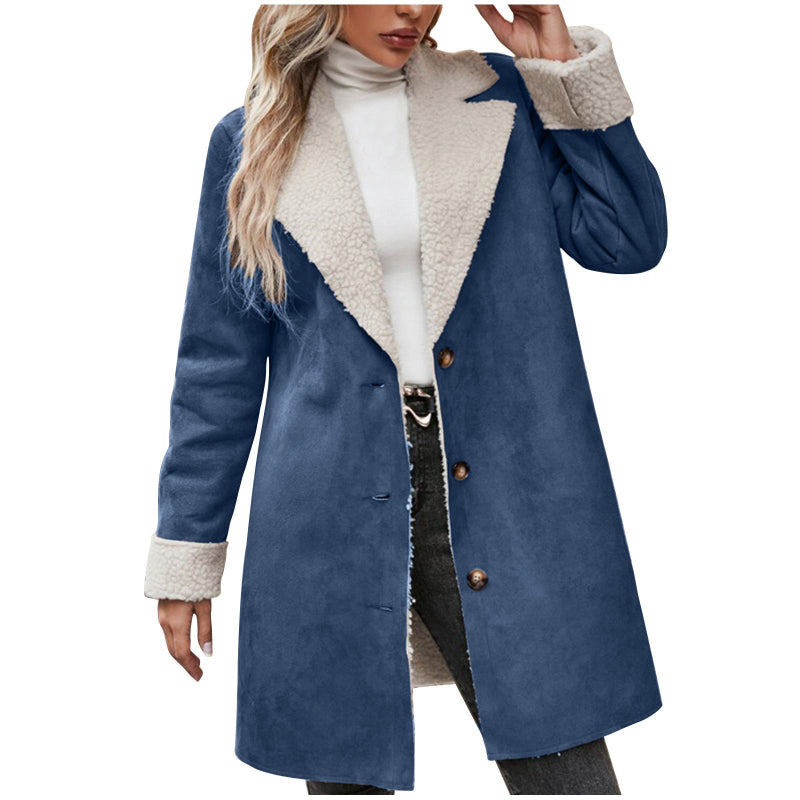 Blue coat with white sherpa lining worn by a person on a white background