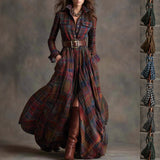 Woman wearing a long plaid dress with a belt and brown boots against a neutral background.