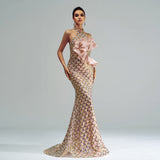 Elegant evening gown with gold scale pattern and pink bow on a plain background