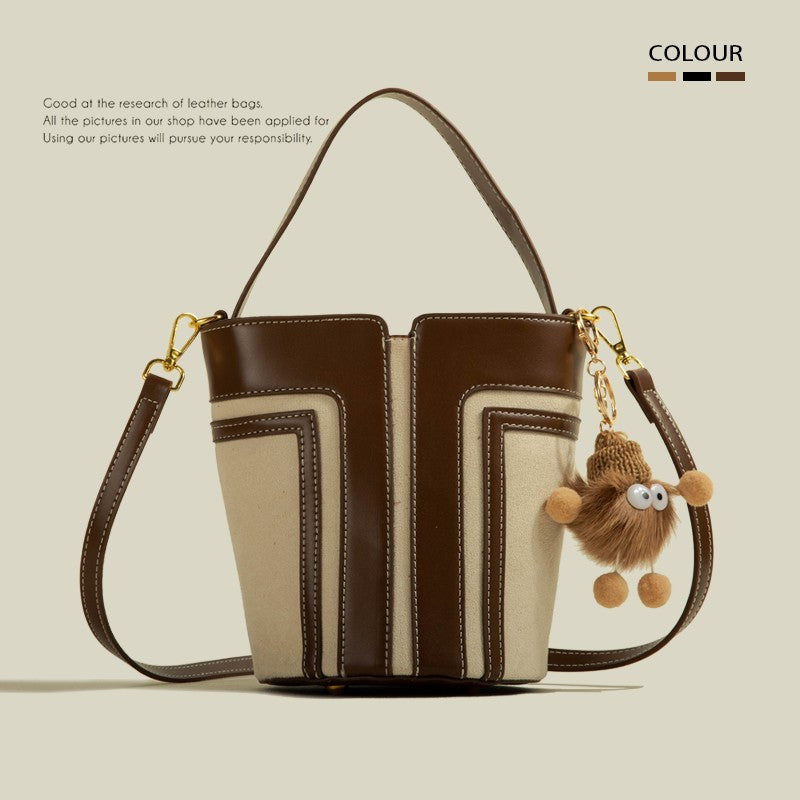 Brown and beige handbag with a keychain on a beige background