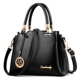 Black handbag with gold accents on a white background