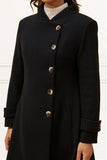 Black coat with silver buttons on a white background