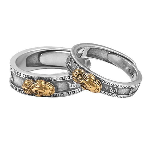Two silver rings with gold accents on a white background