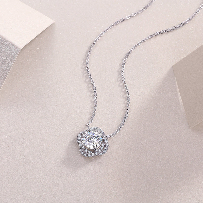 Silver necklace with a sparkling pendant on a light beige background