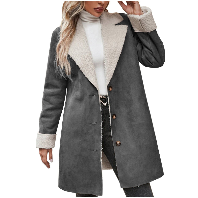 Gray coat with white fur lining worn by a person on a white background