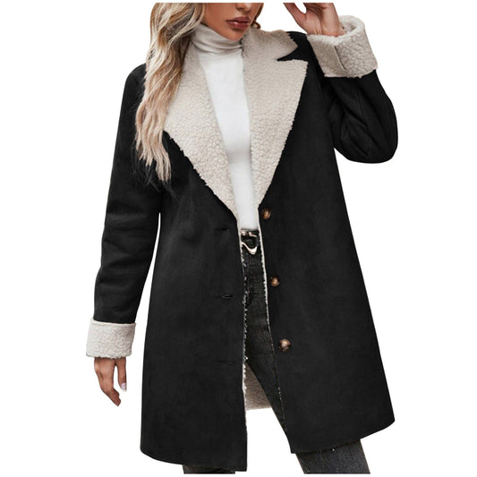 Black coat with white fur collar and cuffs worn by a person on a white background