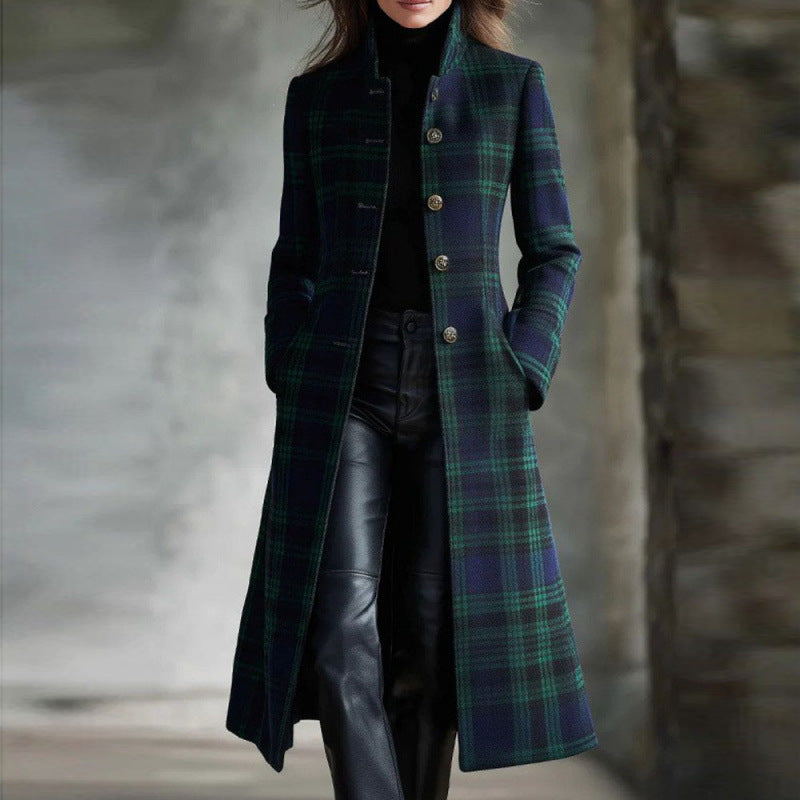 Person wearing a long plaid coat with a blurred background