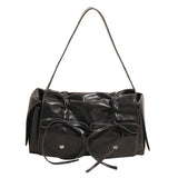 Black handbag with bow details on a white background