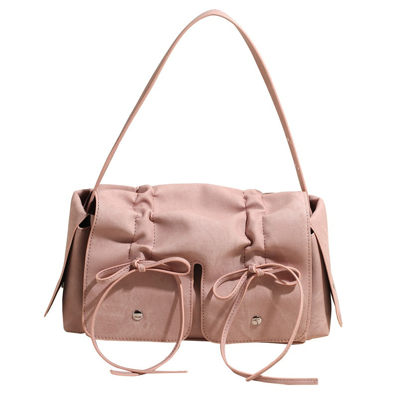 Pink handbag with bow details on a white background
