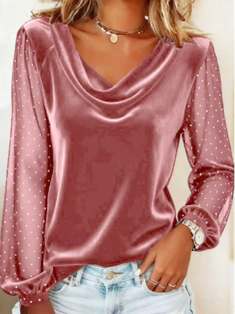 Pink satin blouse with sheer sleeves worn by a person against a neutral background