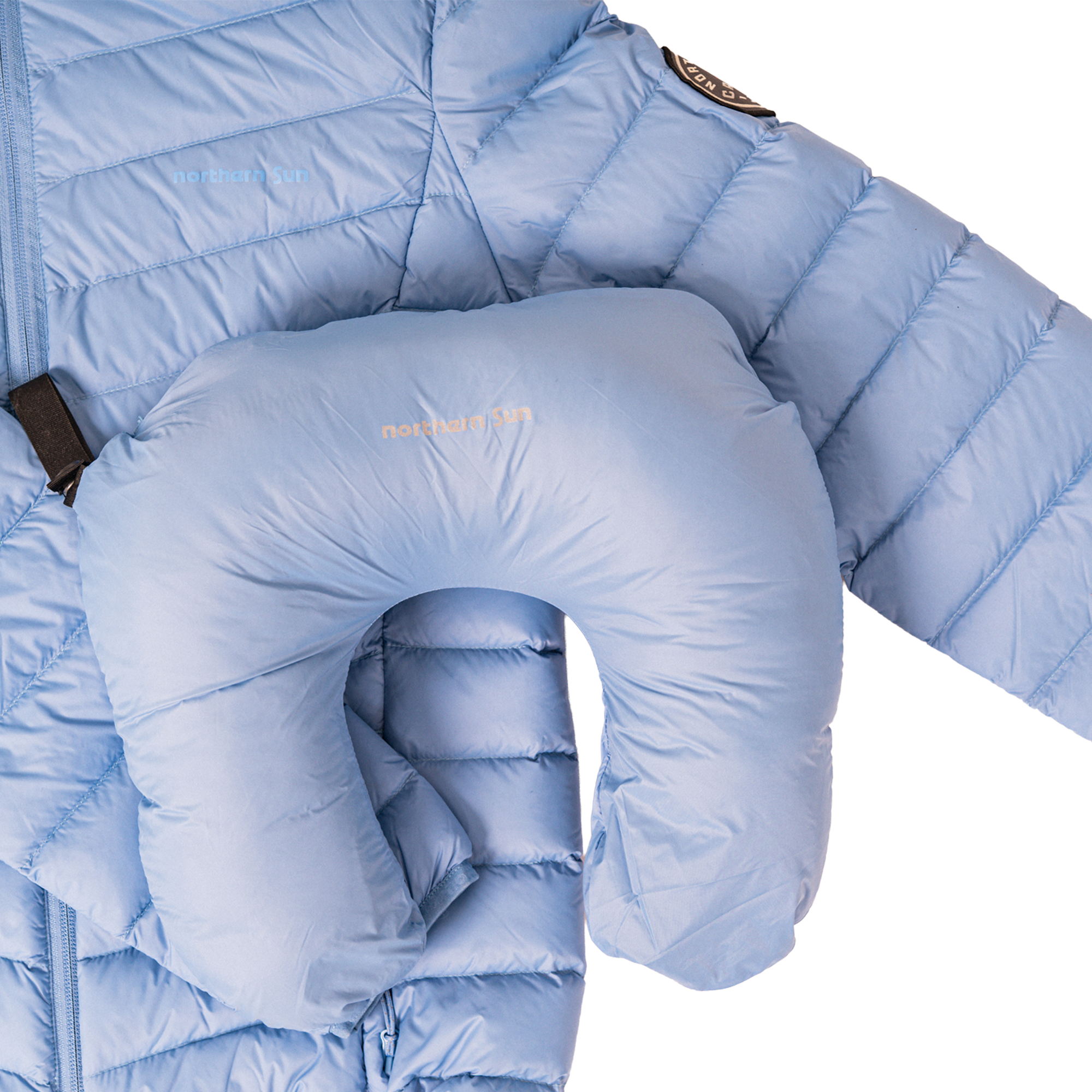 Light blue puffer jacket with a matching neck pillow on a white background