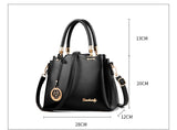 Black handbag with gold accents and measurements on a white background