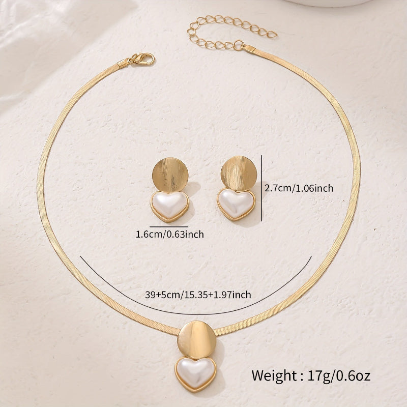 Gold necklace and heart-shaped earrings with measurements on a white background