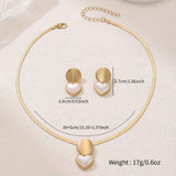 Gold necklace and heart-shaped earrings with measurements on a white background