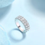 Silver ring with clear gemstones on a light blue background