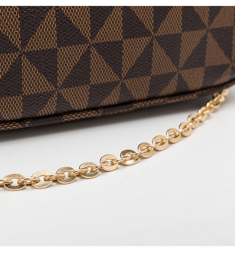 Brown patterned handbag with a gold chain on a white background