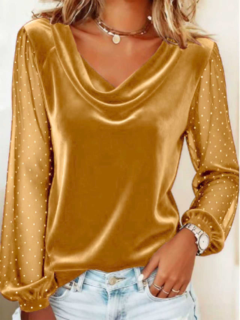 Gold long-sleeve top with mesh panels worn by a person, against a neutral background