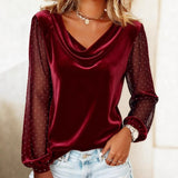 Burgundy velvet top with sheer sleeves worn by a person, against a neutral background