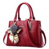 Red handbag with a decorative bow on a white background