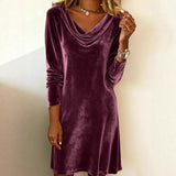 Purple velvet dress worn by a person on a plain background