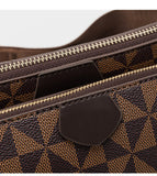 Close-up of a brown patterned bag with a zipper