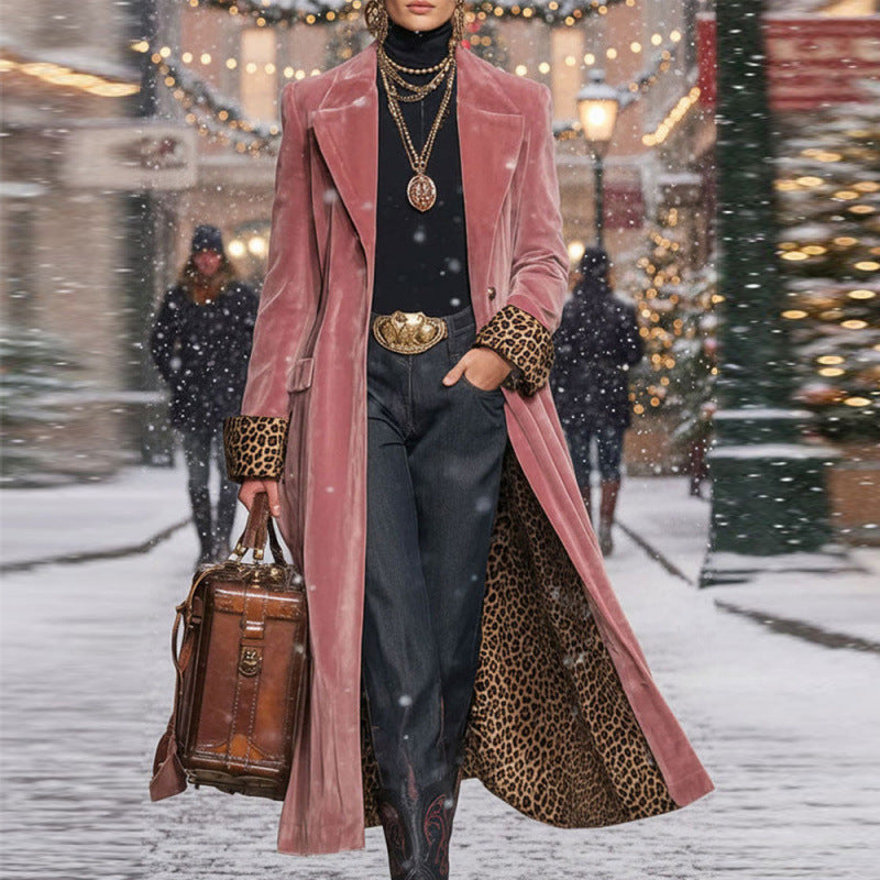 Person wearing a pink coat with leopard print accents in a snowy urban setting